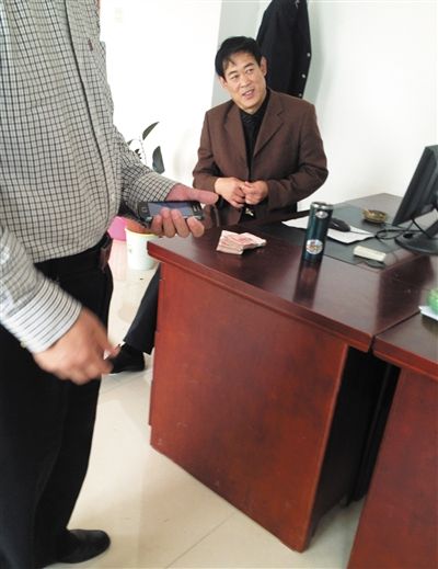 10月29日，獻縣國稅局稽查局辦公室內，一名企業(yè)主交了兩萬元現金在桌上。新京報記者 孟祥超 攝