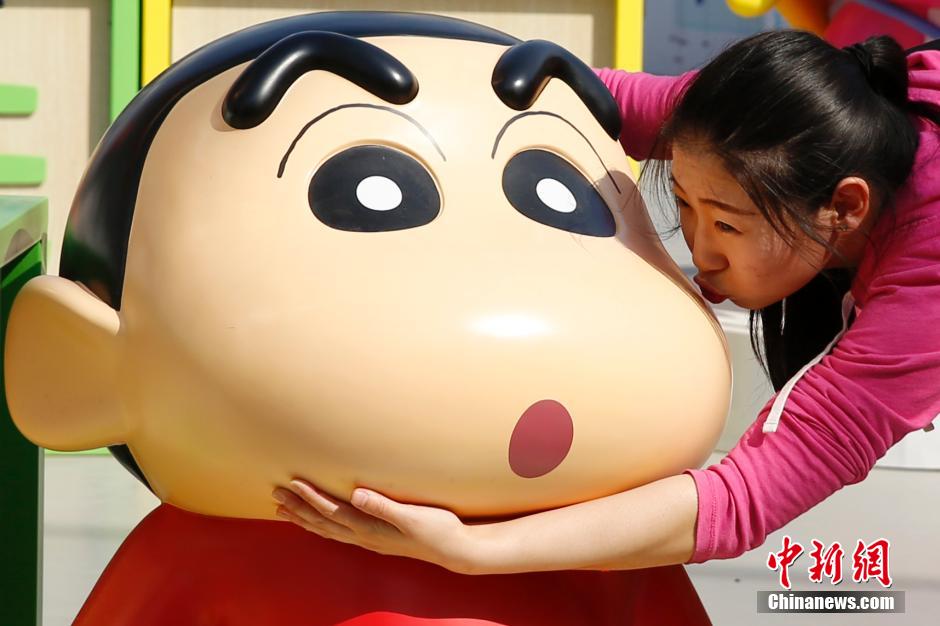 4月22日，游客與蠟筆小新合影?！跋灩P小新25周年紀(jì)念特展”日前在北京開展，吸引了不少市民游客。