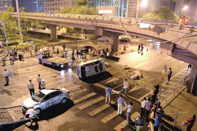 路虎沖下國貿(mào)橋砸中一輛起亞轎車，橋上厚達幾十厘米的水泥護欄被撞斷，碎石四處散落，數(shù)十群眾在現(xiàn)場圍觀。